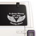 Memorial decal with wings and text on a car window