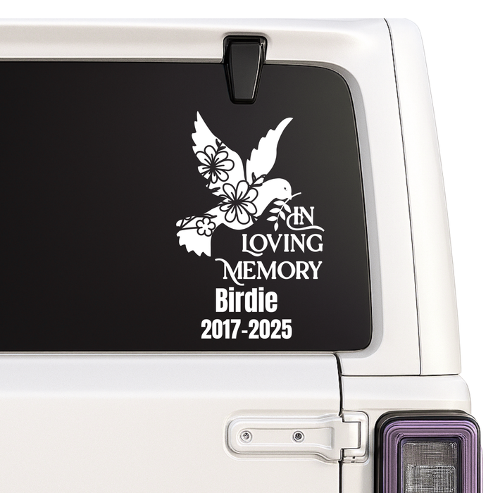 Custom Memorial decal with a dove and flowers on a car window, commemorating 'In Loving Memory