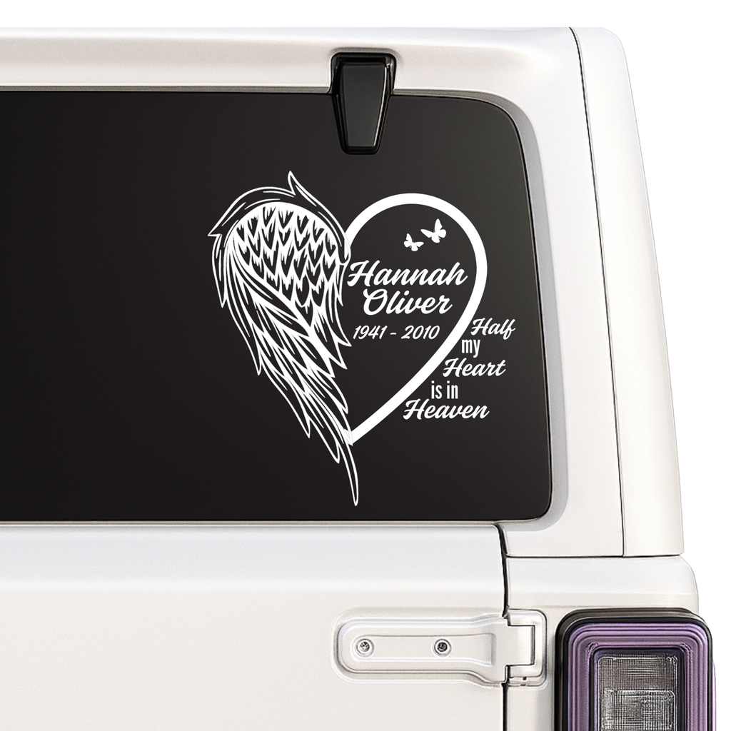 Memorial decal with heart and wings on a car window