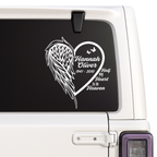 Memorial decal with heart and wings on a car window