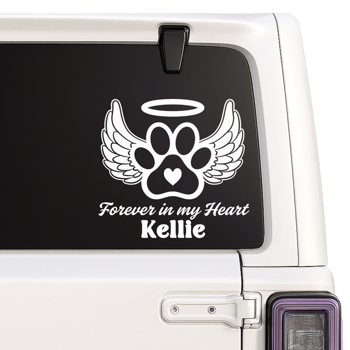 Car window with a paw print memorial decal with wings and 'Forever in my Heart' text.