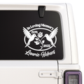Memorial decal with two birds and text on a car window