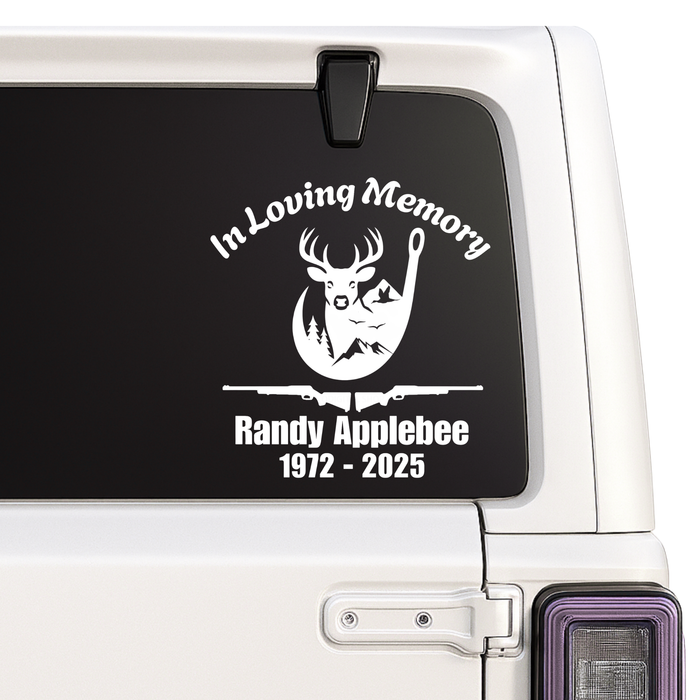 Memorial decal with a deer and rifle design on a vehicle window.