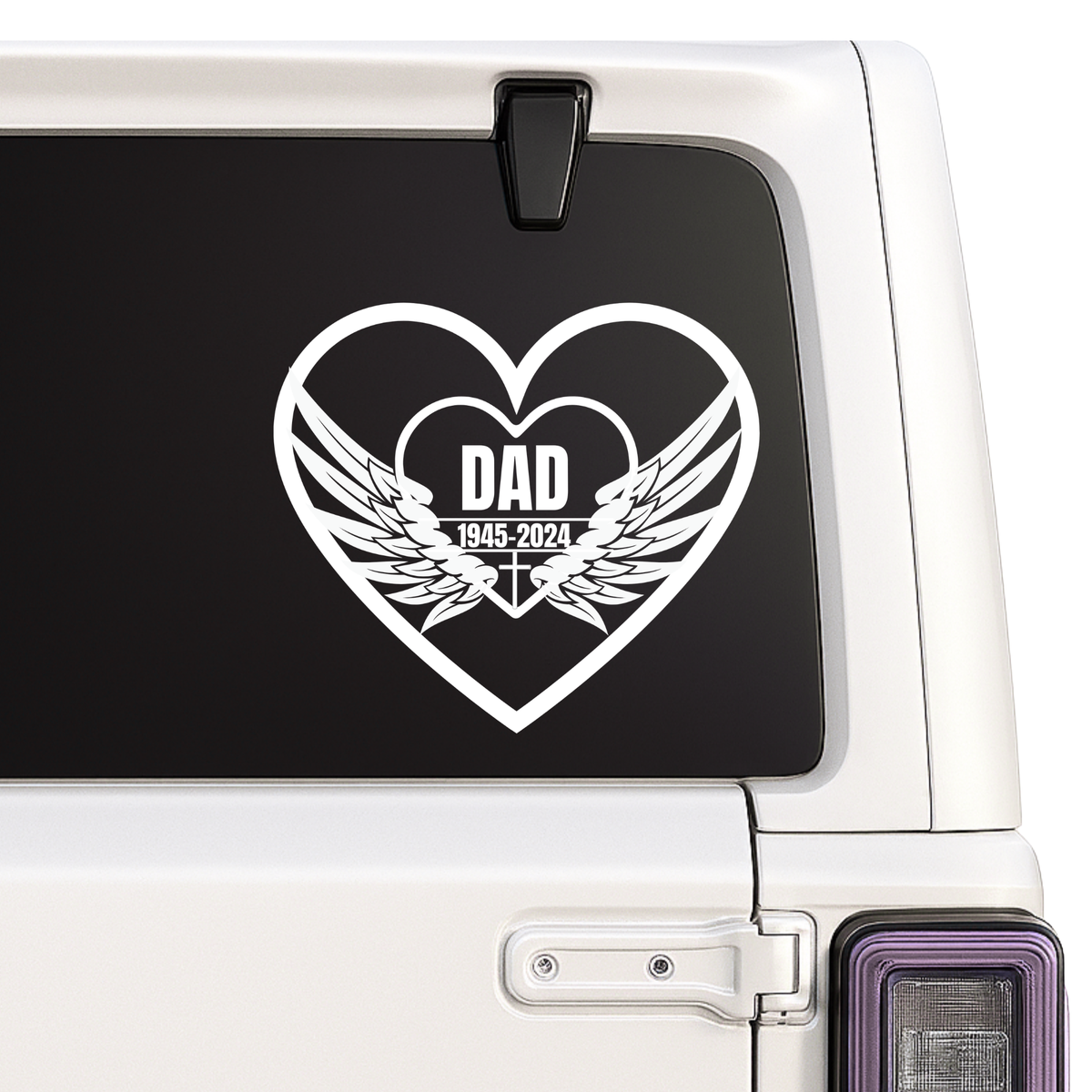 Heart-shaped decal with 'DAD' and wings on a car window.