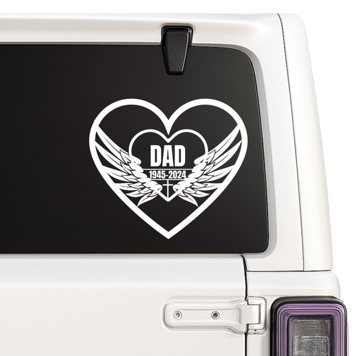 Heart-shaped decal with 'DAD' and wings on a car window.