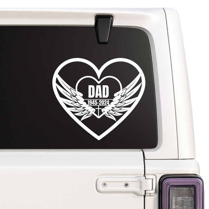 Heart-shaped decal with 'DAD' and wings on a car window.