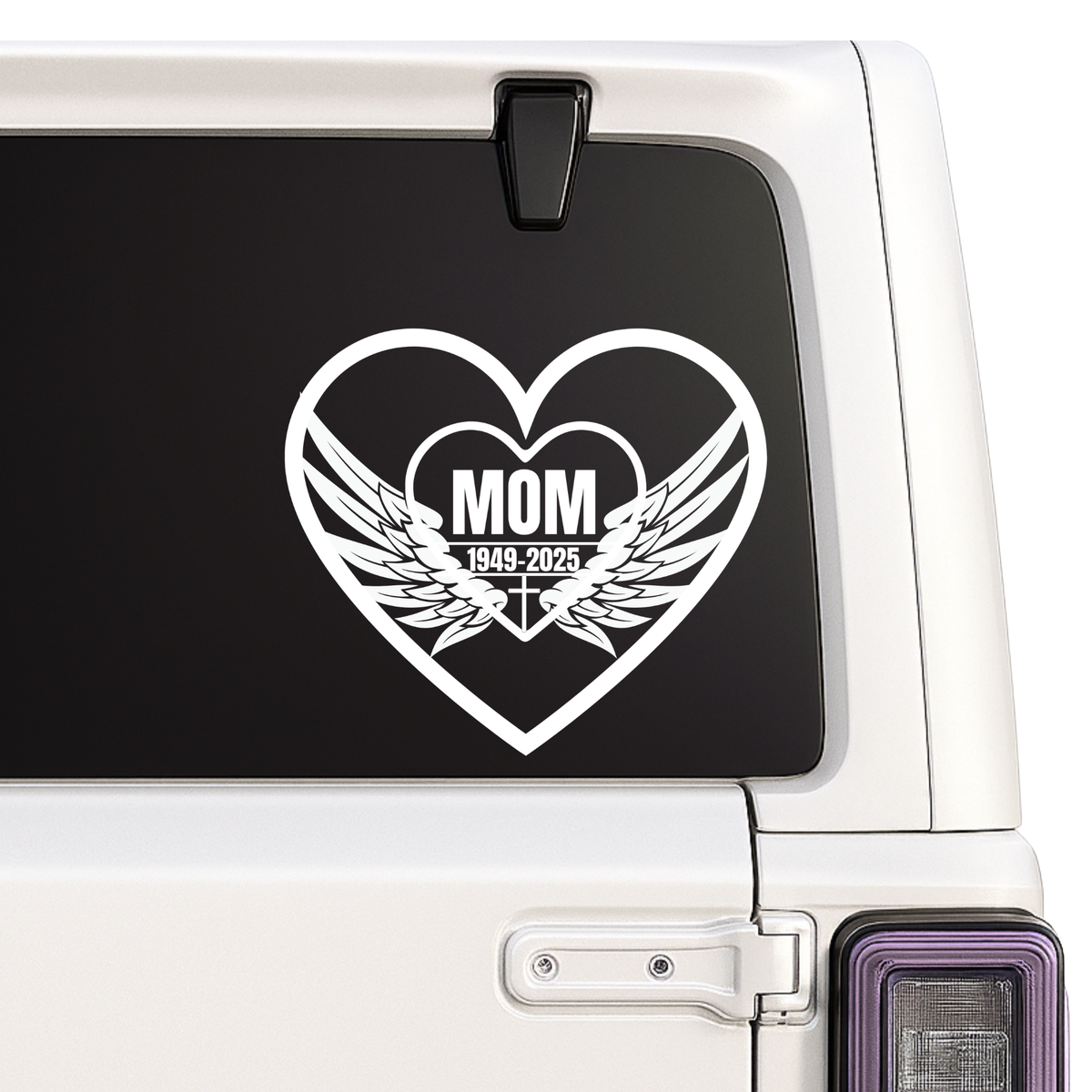 Heart-shaped decal with 'MOM' and wings on a car window.
