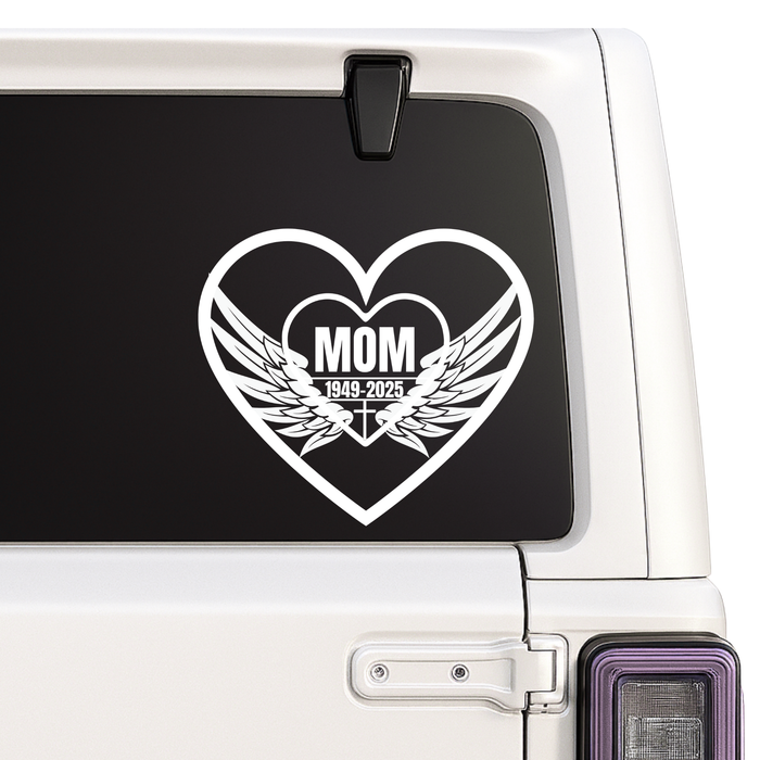 Heart-shaped decal with 'MOM' and wings on a car window.