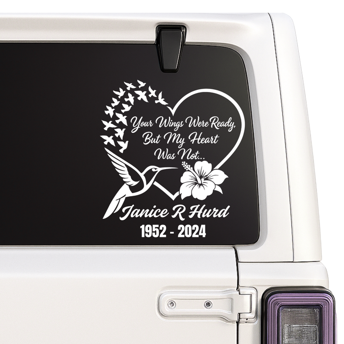 Memorial decal with text and birds on a car window
