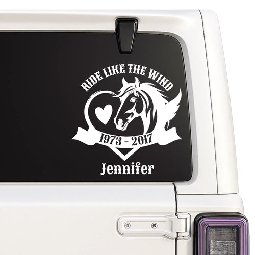 Car window with a decal featuring a horse and text on a black background