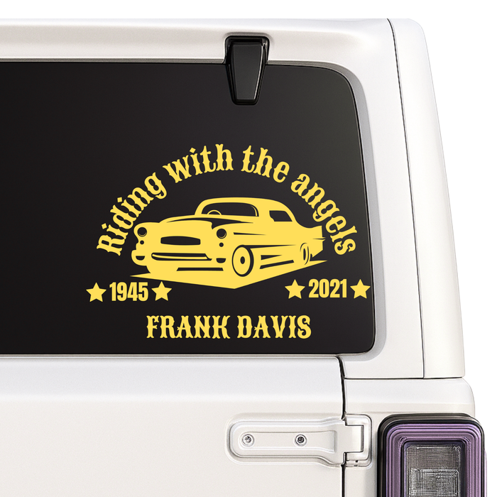 Car window with a yellow graphic and text on a black background