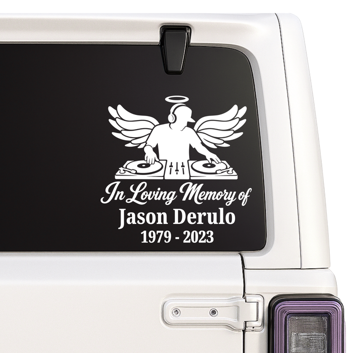 Memorial decal with angel and DJ equipment on a car window.