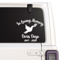 Memorial decal with 'In Loving Memory' text and dove design on a vehicle window.