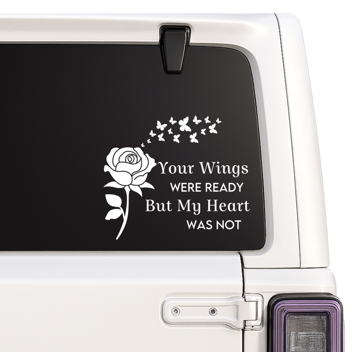 Decal with a rose and butterflies on a car window with text.