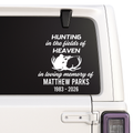 Memorial decal with text and silhouette of a deer on a vehicle window.