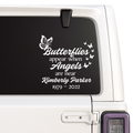 Memorial decal with butterfly design and text on a car window.
