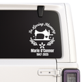 Memorial decal with sewing machine design on a vehicle window.