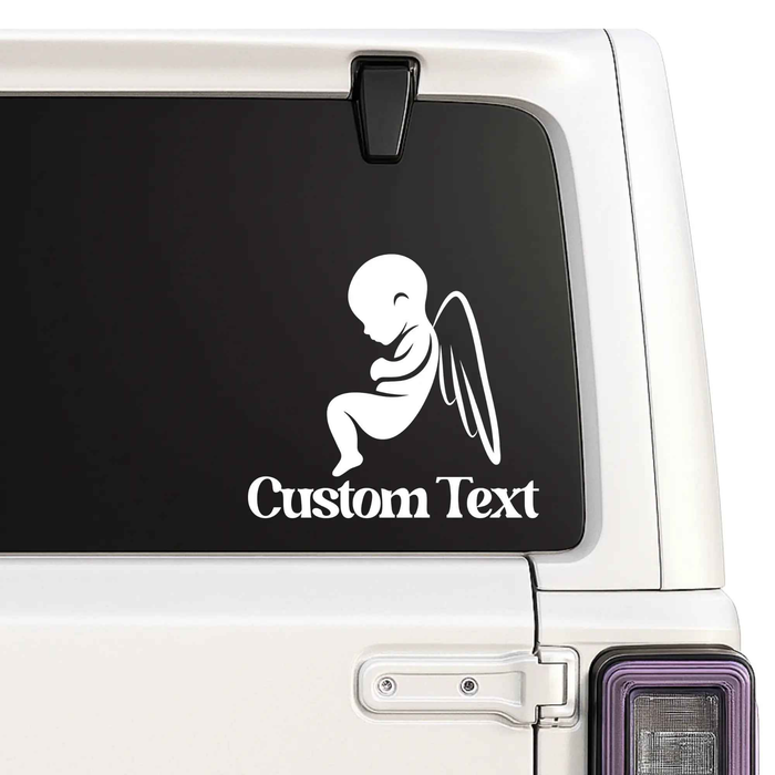 Car window with a decal of a baby silhouette and 'Custom Text' on a black background