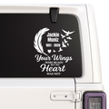Memorial decal with text and feather design on a vehicle window.
