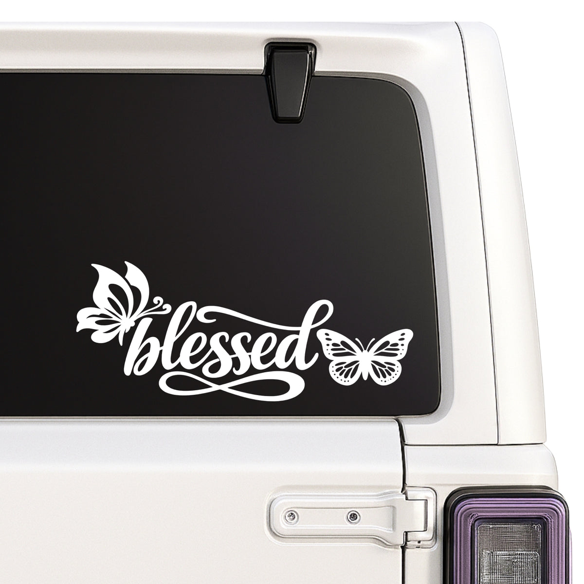 Blessed — butterfly script design design shown on a white Jeep window