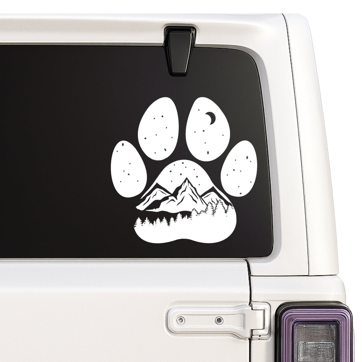 Mountain landscape inside paw print design shown on a white Jeep window