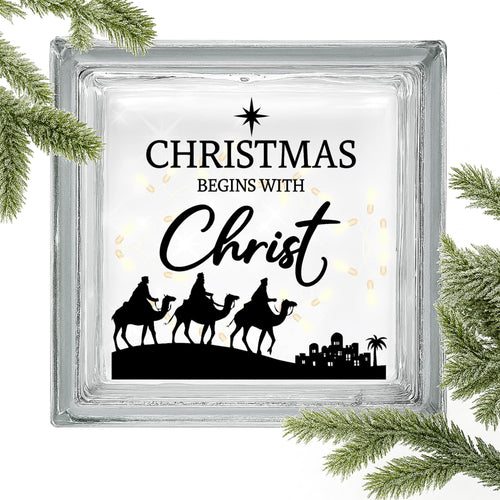 Set of two Christmas Begins with Christ vinyl decals by Nostalgi Factory featuring faith-based holiday message on white background.