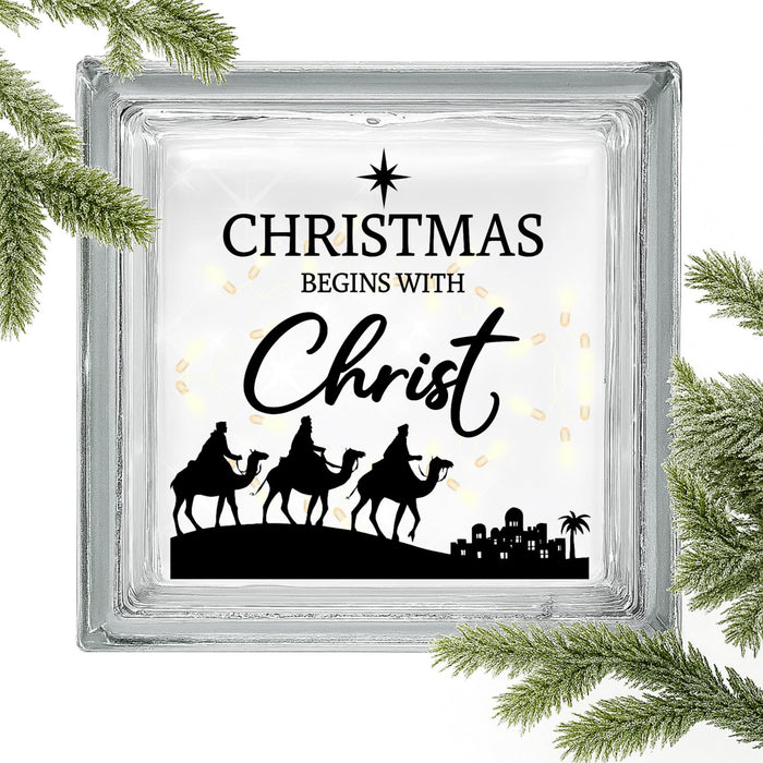 Set of two Christmas Begins with Christ vinyl decals by Nostalgi Factory featuring faith-based holiday message on white background.