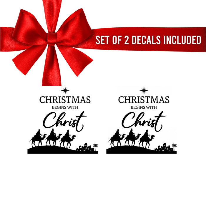 Set of two Christmas Begins with Christ vinyl decals by Nostalgi Factory, faith-based holiday decor stickers on a white background.