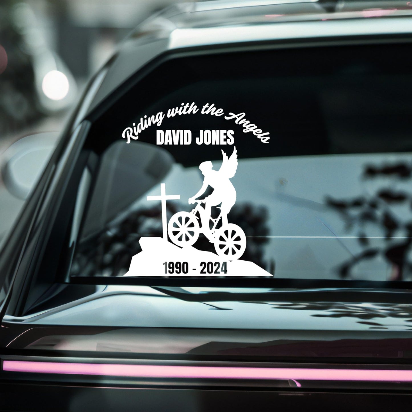 Custom riding with the angels memorial vinyl decal featuring a bike angel design on a car window in multiple colors.