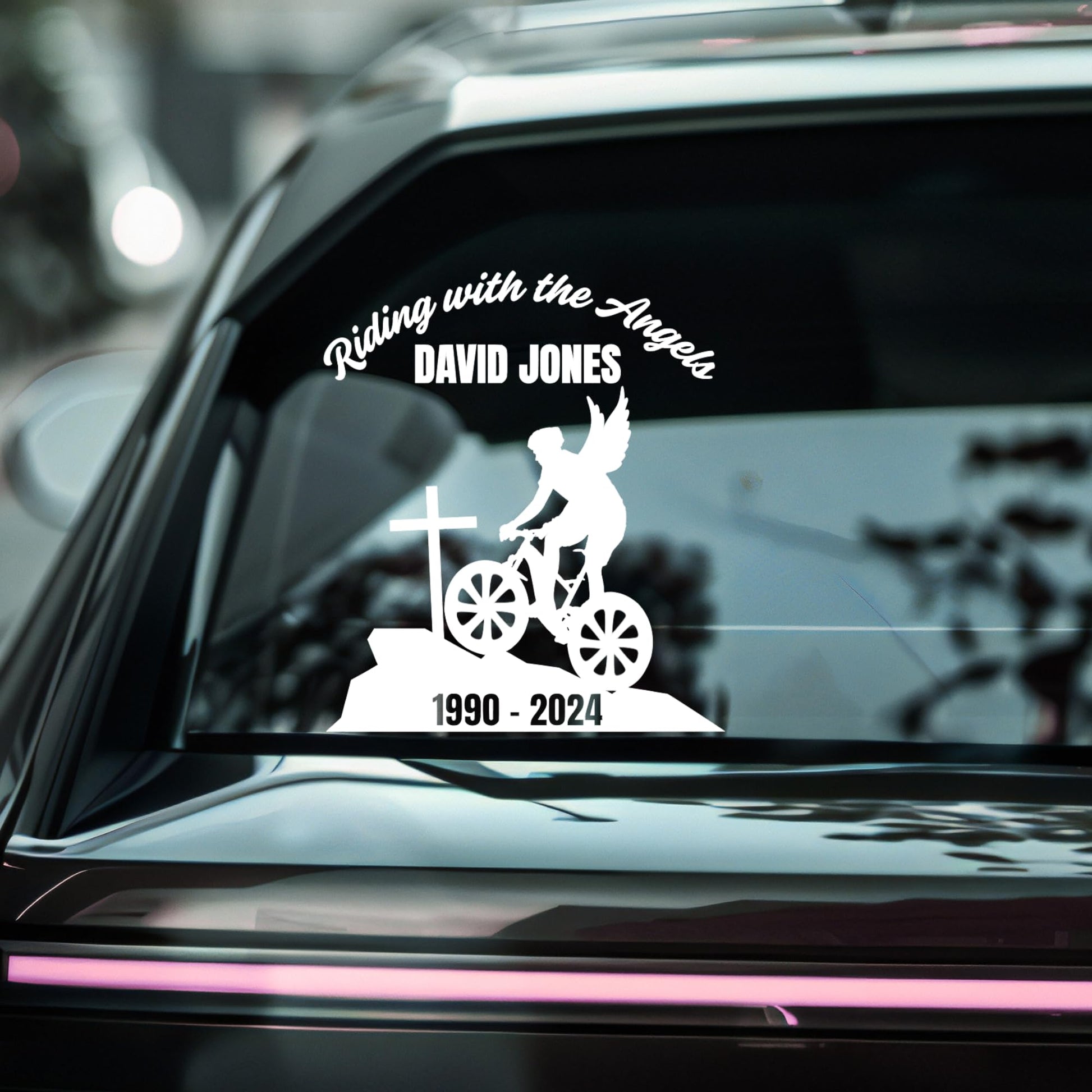 Custom riding with the angels memorial vinyl decal featuring a bike angel design on a car window in multiple colors.